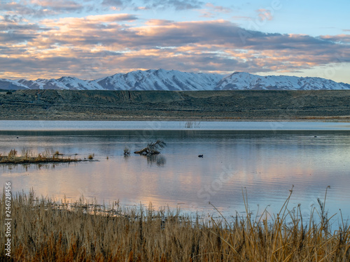 Swan Lake Nevada landscape photograph with snow capped mountains in the background.
