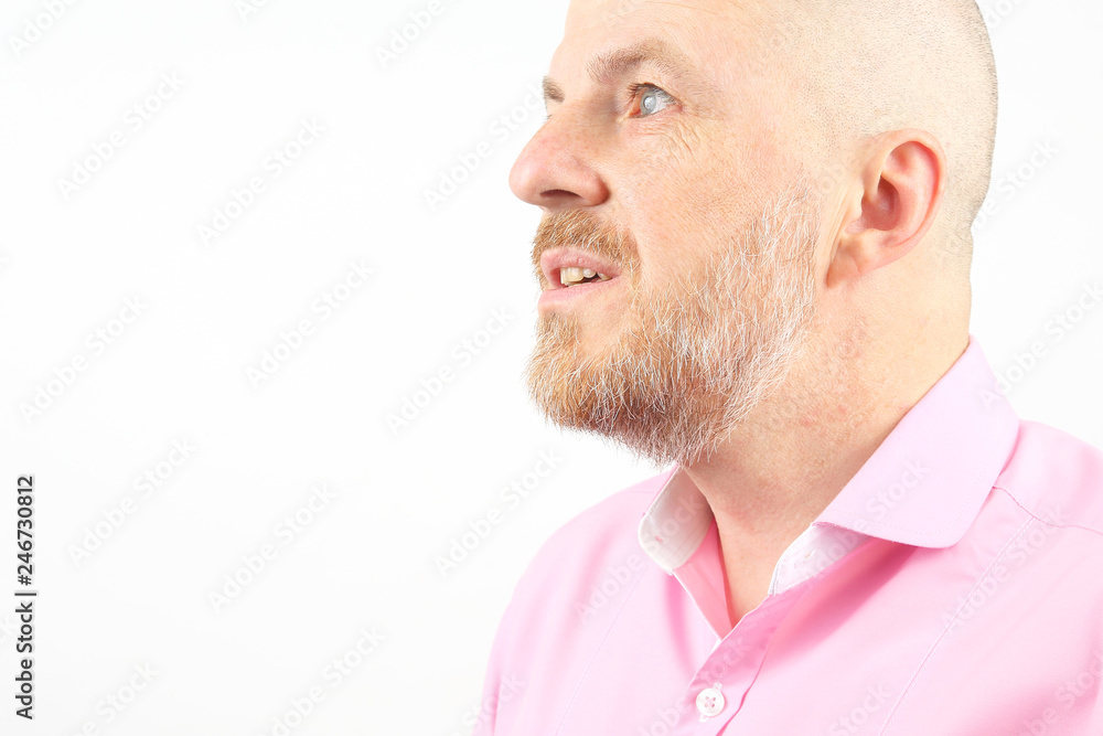 Fototapeta premium Studio portrait of a bearded man in a pink shirt