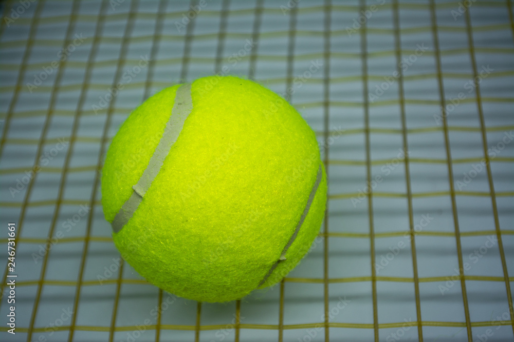 Yellow tennis ball that is sport equipment for tennis as international sport around the world.