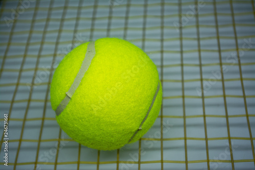 Yellow tennis ball that is sport equipment for tennis as international sport around the world. © Thanaphon