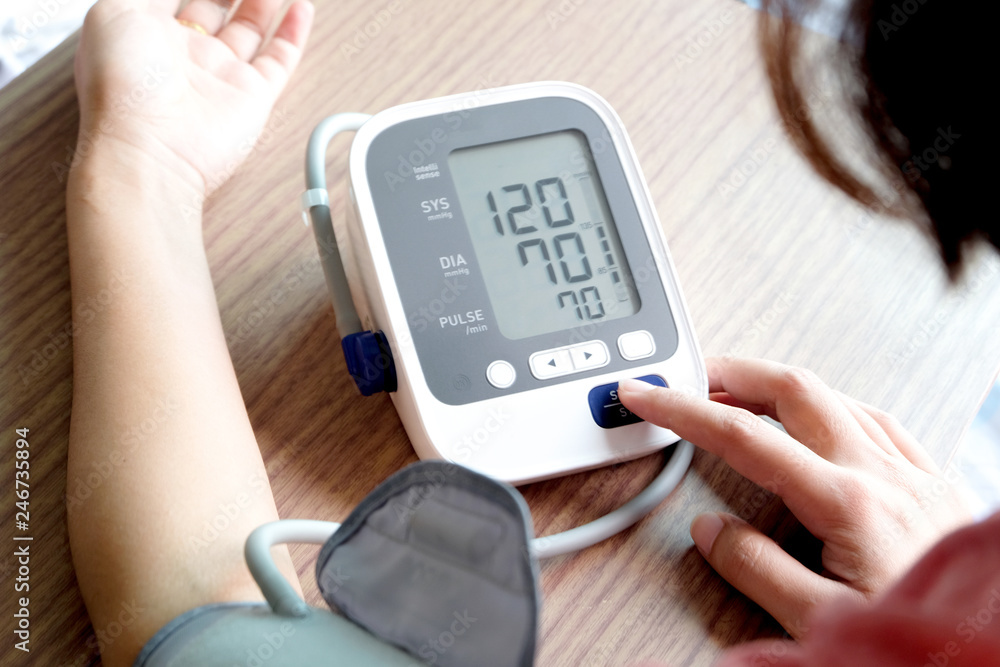 Human check blood pressure monitor and heart rate monitor with digital pressure gauge. Health care and Medical concept Human check blood pressure monitor and heart rate monitor with digital pressure gauge. Health care and Medical concept