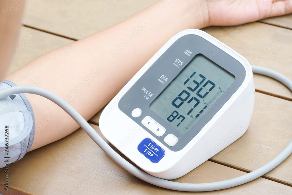 Human check blood pressure monitor and heart rate monitor with digital pressure gauge. Health care and Medical concept Human check blood pressure monitor and heart rate monitor with digital pressure gauge. Health care and Medical concept