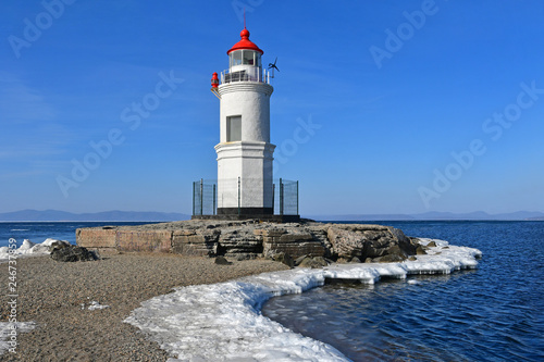 Russia. Vladivostok. The  lighthouse of Egersheld 1876 year built  Tokarevskaya koshka in winter sunny day in Amur bay