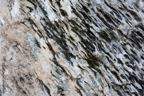 The texture of old stone wall. It is a beautifull natural patterned surface with white and gray