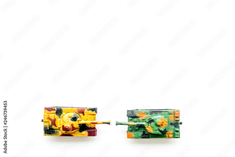 Obraz premium War concept. Tanks toy on white background top view copy space