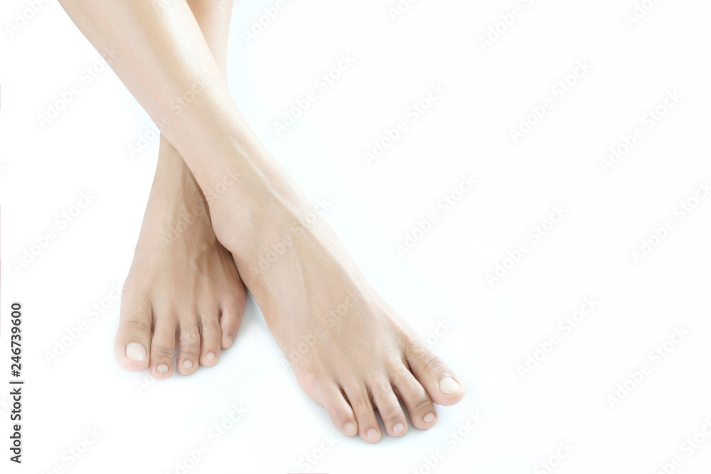 Beautiful female legs and feet on a white background.Concept beauty and hydration of the skin. Beautiful female legs and feet on a white background.Concept beauty and hydration of the skin.