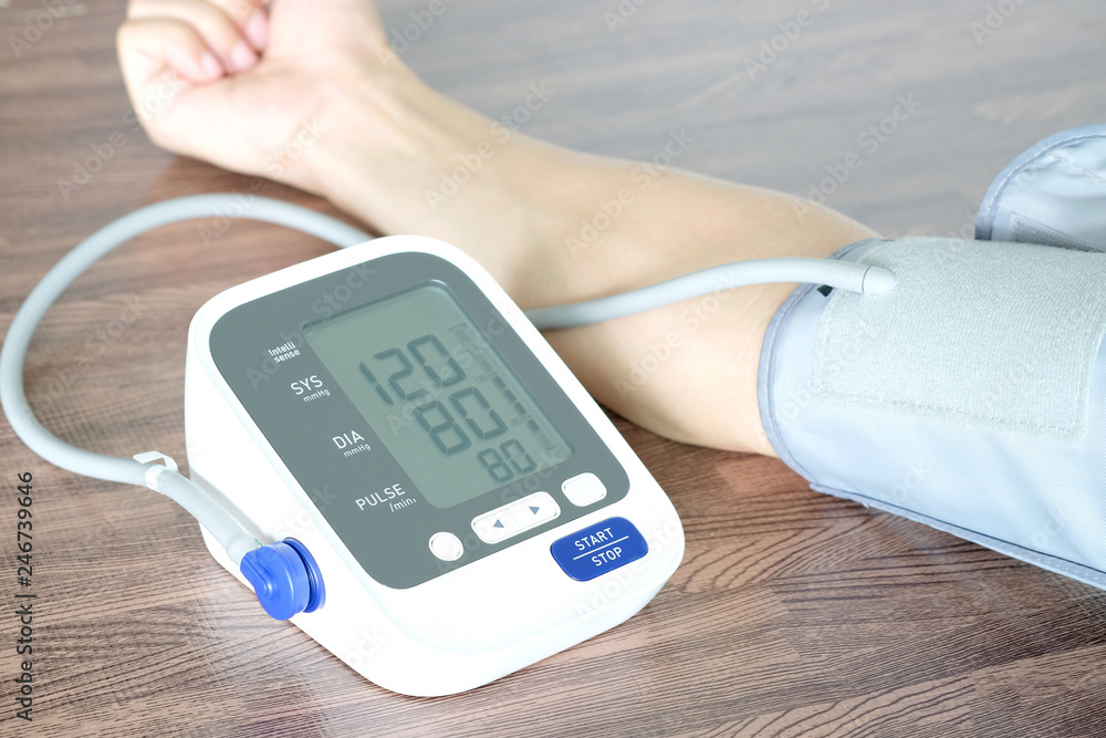 Human check blood pressure monitor and heart rate monitor with digital pressure gauge. Health care and Medical concept Human check blood pressure monitor and heart rate monitor with digital pressure gauge. Health care and Medical concept