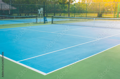 Empty outdoor blue tennis hard court in public park. (Selective focus) © Angkana
