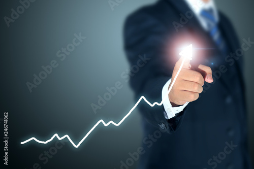 businessman pointing graph of success