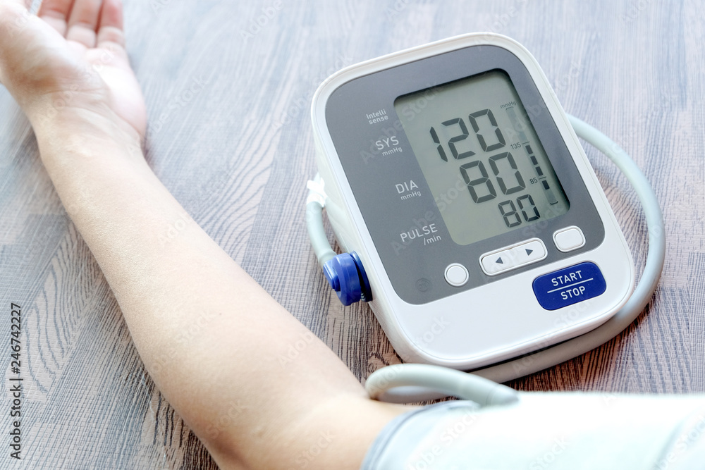 Human check blood pressure monitor and heart rate monitor with digital pressure gauge. Health care and Medical concept Human check blood pressure monitor and heart rate monitor with digital pressure gauge. Health care and Medical concept