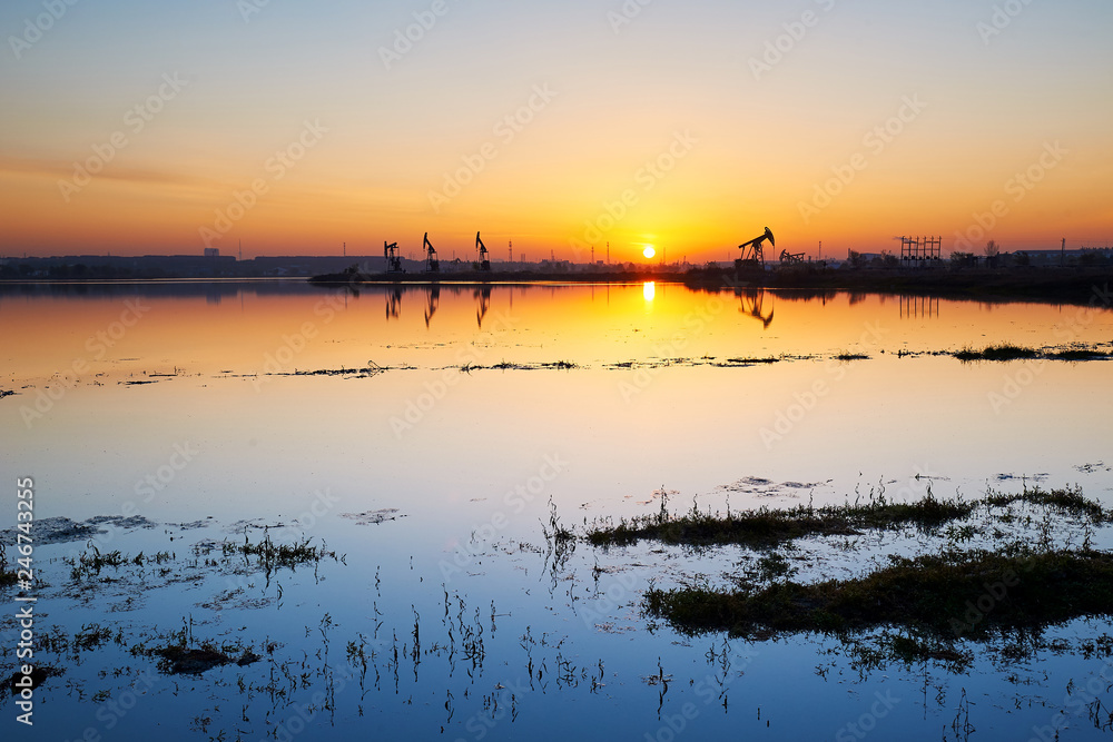 The oil fields of lakeside sunrise.
