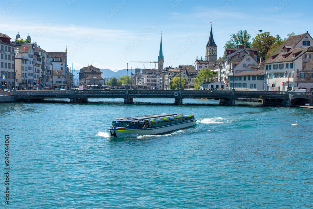Boat crosses the river in downtown Zurich, Switzerland.