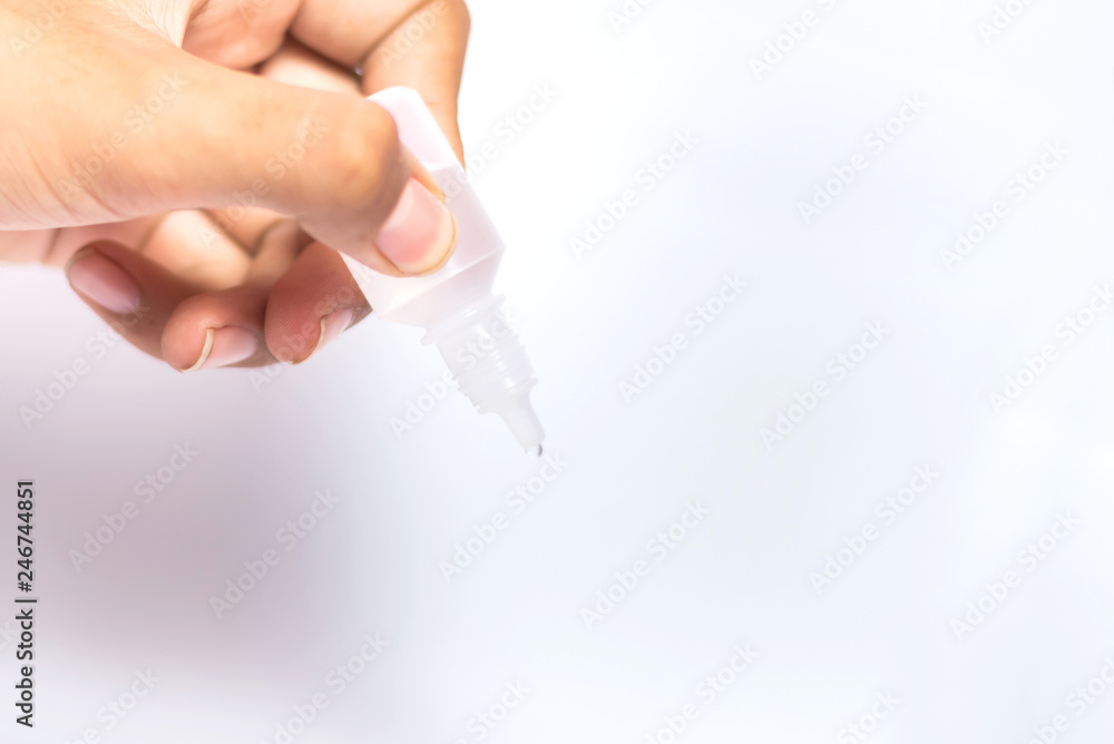 Man holding and droping eye dropper on white background Man holding and droping eye dropper on white background