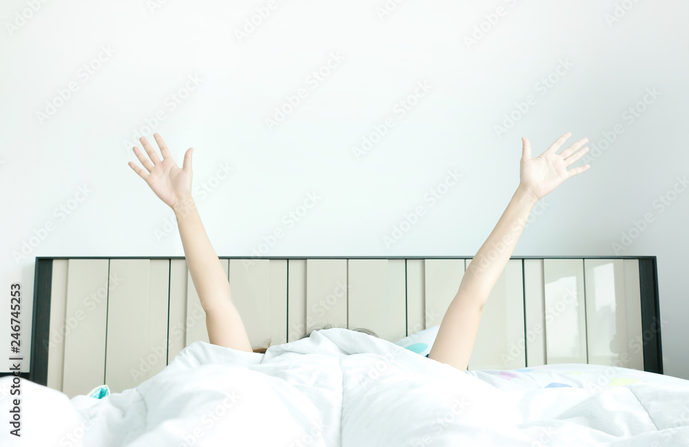 Morning of a new day, alarm clock wake up man sitting in the room. A man stretch the muscles at window. Health and care concepts Morning of a new day, alarm clock wake up man sitting in the room. A man stretch the muscles at window. Health and care concepts