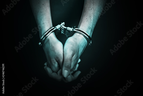 Business Man's hand in handcuff, crime arrested concept