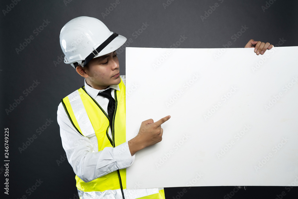 asian construction man holding a promotional card for copy space in gray background asian construction man holding a promotional card for copy space in gray background
