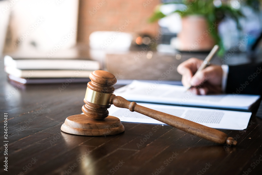 Legal counsel presents to the client a signed contract with gavel and legal law. justice and lawyer concept. Legal counsel presents to the client a signed contract with gavel and legal law. justice and lawyer concept.