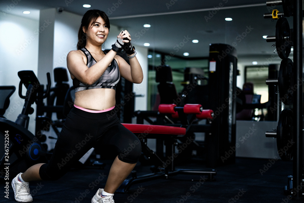 Beautiful woman exercise in fitness to tighten the puppet.Lose weight with cardio to lose fat and build muscle.woman in fitness suite exercise workout in gym.