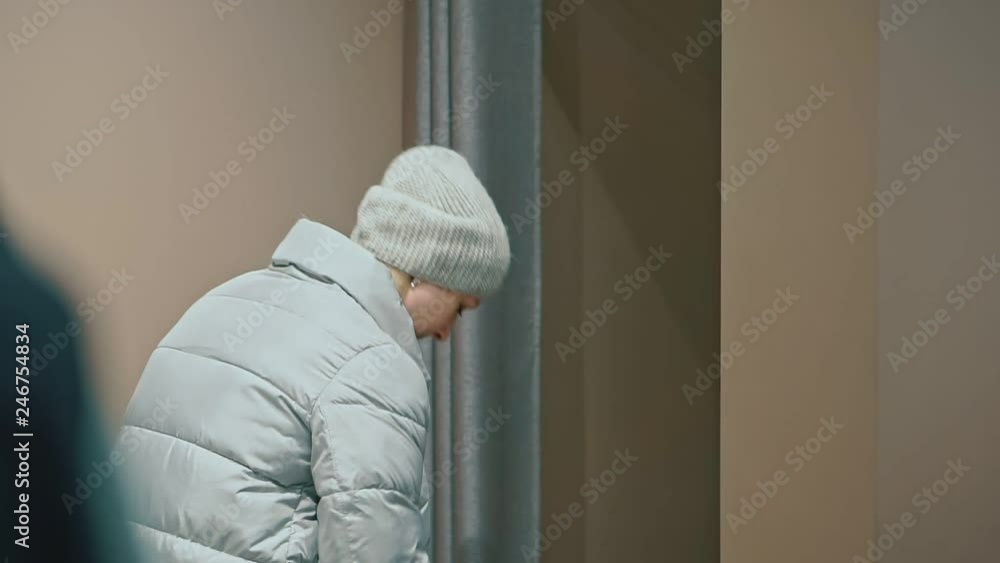 Attractive woman trying on a new down jacket in a clothing store. Attractive woman trying on a new down jacket in a clothing store.