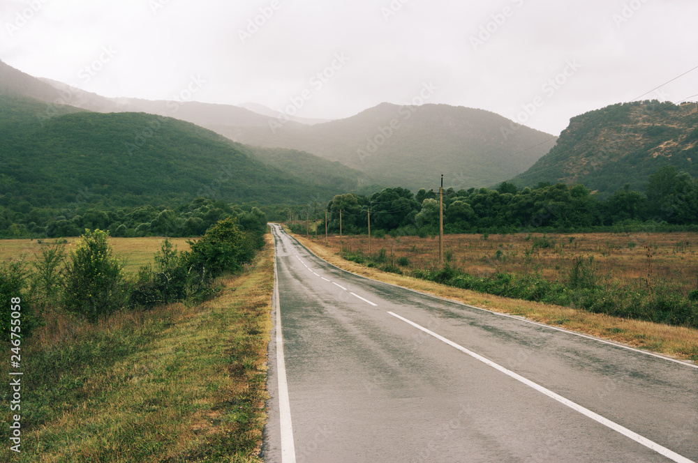 Wet asphalt road at rainy day