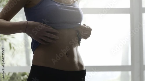 Young woman showing her flat belly photo