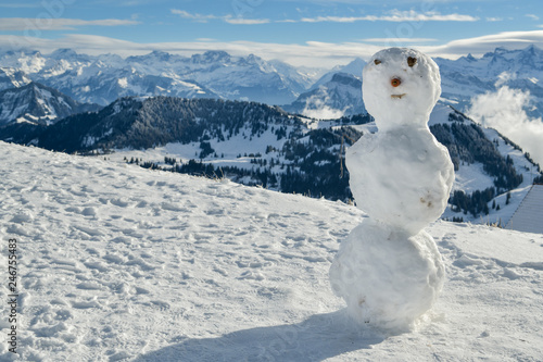 Snowman on top of Mount Rigi with beautiful views on Swiss Alps