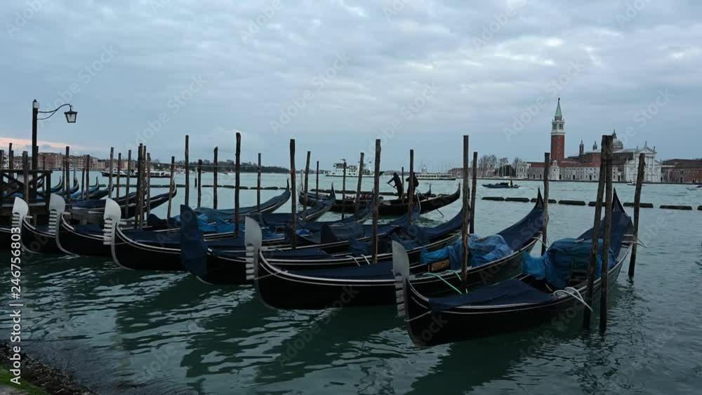 Gondolas and other boats at dusk in the basin of San Marco Gondolas and other boats at dusk in the basin of San Marco