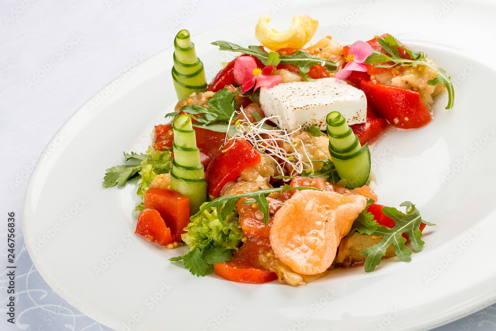 Bright vegetable salad with tofu and rice chips.