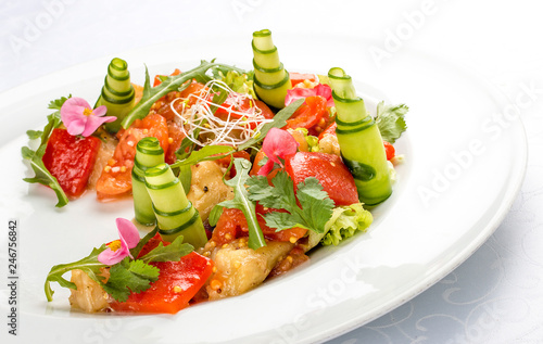 Bright vegetable salad with tofu and rice chips.