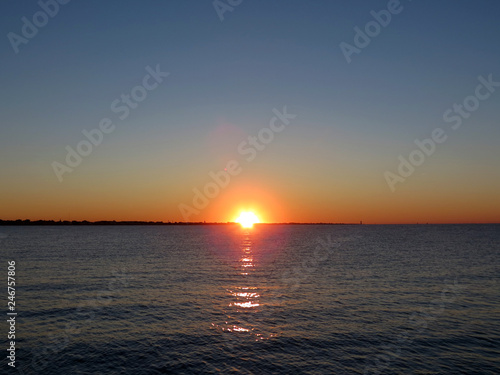 Beautiful sunset over the Adriatic sea,  berth in Rimini, Italy, Europe. The hot  sun sets in the warm water. © Pavel