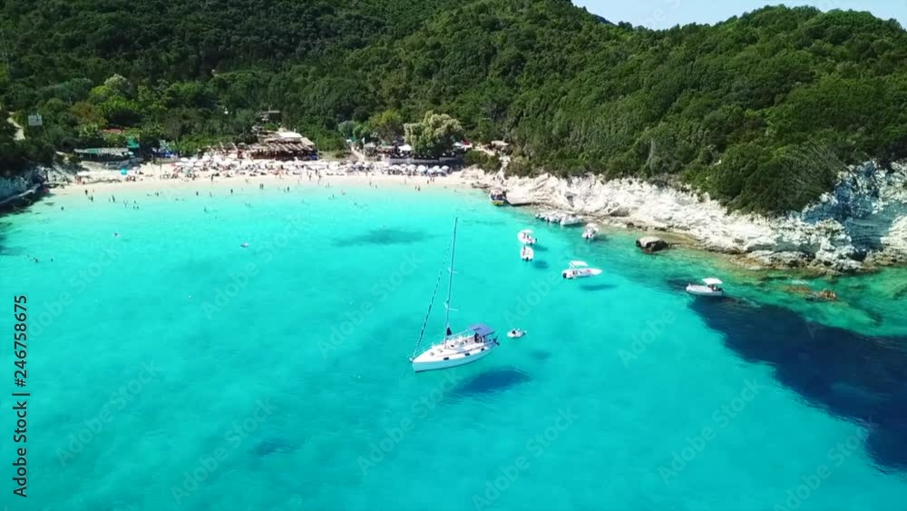 Aerial drone video of tropical paradise turquoise beach of Voutoumi with sail boats docked in island of Antipaxos, Ionian, Greece Aerial drone video of tropical paradise turquoise beach of Voutoumi with sail boats docked in island of Antipaxos, Ionian, Greece