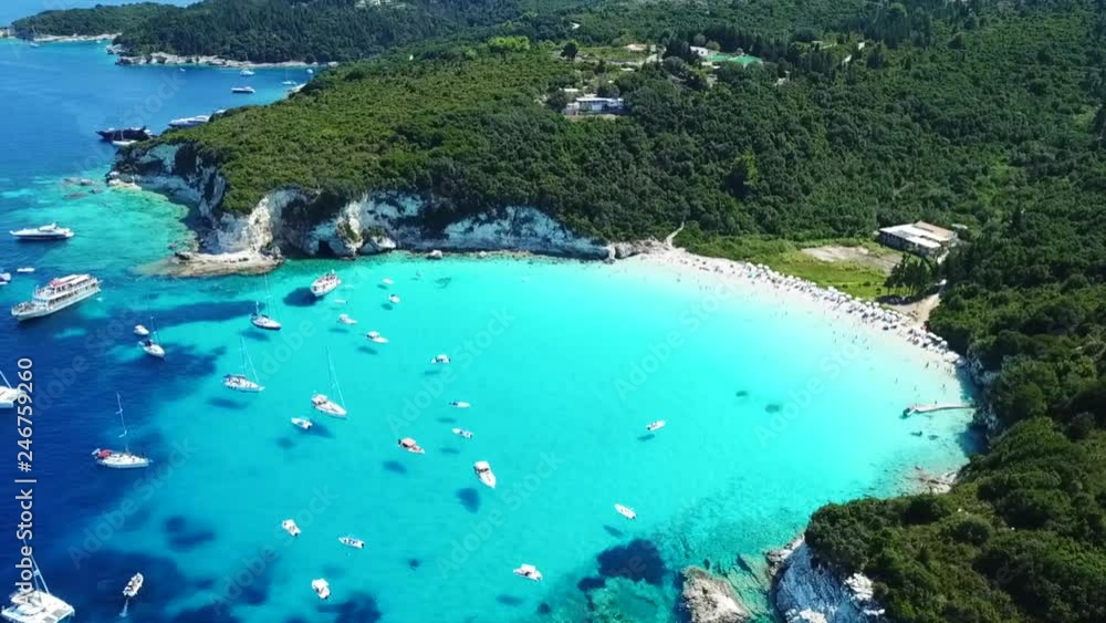 Aerial drone video of tropical paradise turquoise beach of Voutoumi with sail boats docked in island of Antipaxos, Ionian, Greece Aerial drone video of tropical paradise turquoise beach of Voutoumi with sail boats docked in island of Antipaxos, Ionian, Greece