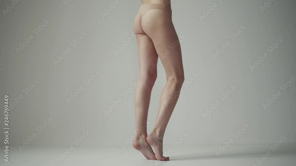 sexy female legs. back view. the girl is standing on tiptoes and shifting from foot to foot. sexy female legs. back view. the girl is standing on tiptoes and shifting from foot to foot.