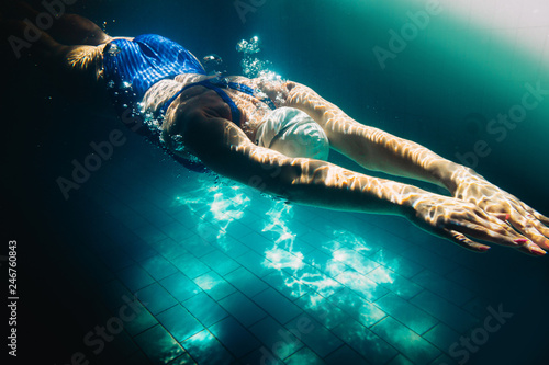 Female swimmer at the swimming pool.Underwater photo.