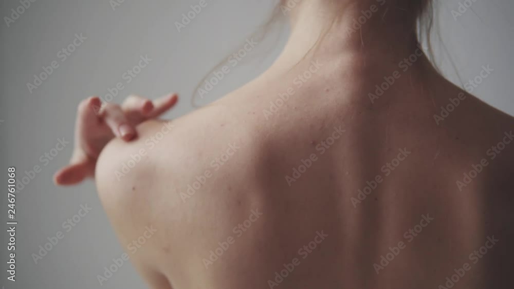 female shoulders close up. girl touches her neck and shoulders female shoulders close up. girl touches her neck and shoulders