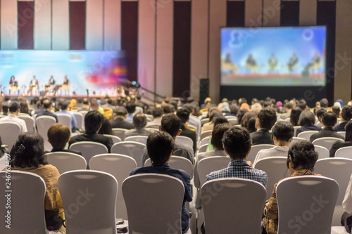 Rear view of Audience listening Speakers on the stage in the conference hall or seminar meeting, business and education about investment concept