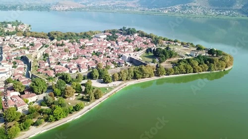 Aerial drone bird's eye view video of iconic city, castle with mosque in lake of Ioannina surounded by famous lake and mountains of Pindus, Epirus, Greece photo