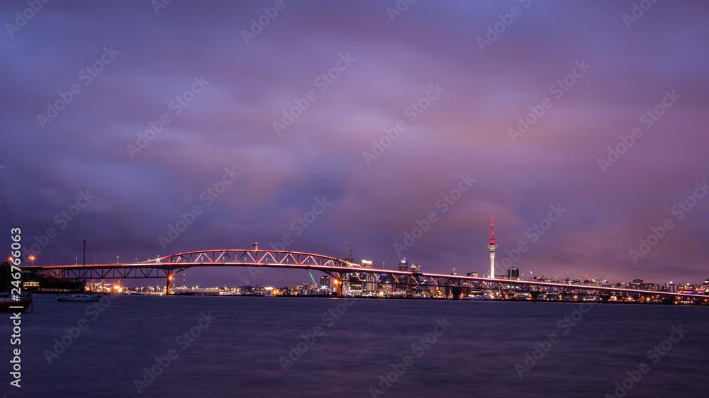 Auckland Harbour Bridge lit up in golden hour for Auckland Anniversary to celebrate the city's birthday