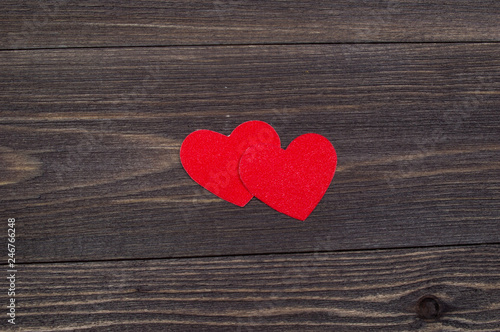 Two paper hearts on a wooden table on Valentine s Day