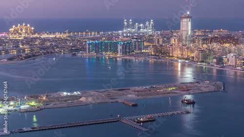 Aerial view of Palm Jumeirah Island day to night timelapse.