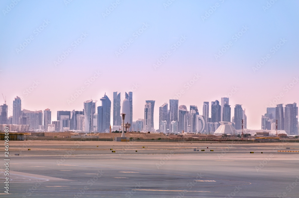 Doha skyline. Cityscape of Qatar capital. View from airport. Futuristic urban landscape of Doha. Doha skyline. Cityscape of Qatar capital. View from airport. Futuristic urban landscape of Doha.