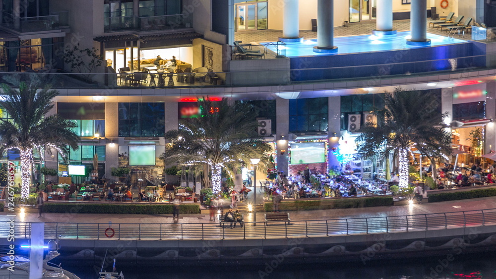 Luxury Dubai Marina canal with passing boats and promenade night timelapse, Dubai, United Arab Emirates Luxury Dubai Marina canal with passing boats and promenade night timelapse, Dubai, United Arab Emirates