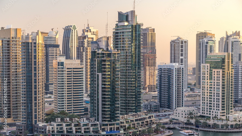 Beautiful aerial view of Dubai Marina promenade and canal with floating yachts and boats before sunset in Dubai, UAE. Beautiful aerial view of Dubai Marina promenade and canal with floating yachts and boats before sunset in Dubai, UAE.
