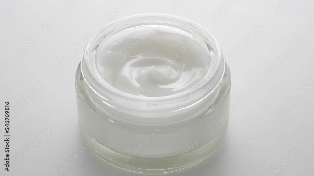 Cosmetics cream with rotate. Cream white background texture. Close-up shot. Cosmetics cream with rotate. Cream white background texture. Close-up shot.
