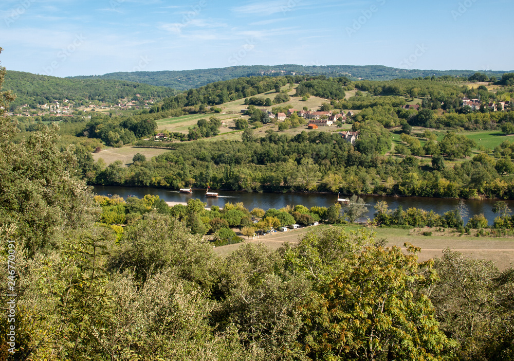  A tourist boats, in French called gabare, on the river Dordogne at La Roque-Gageac, Aquitaine, France