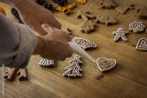 Christmas gingerbread icing decorating process. Homemade sweet cookies