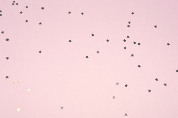 Silver glitter stars on pink background in vintage colors