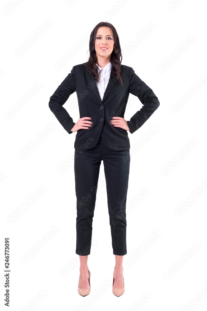 Confident corporate business woman standing with arms on hips looking at camera and smiling. Full body isolated on white background. Confident corporate business woman standing with arms on hips looking at camera and smiling. Full body isolated on white background.