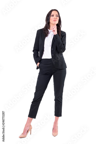 Confident serious successful business woman planning and thinking with hand on chin looks away. Full body isolated on white background. 