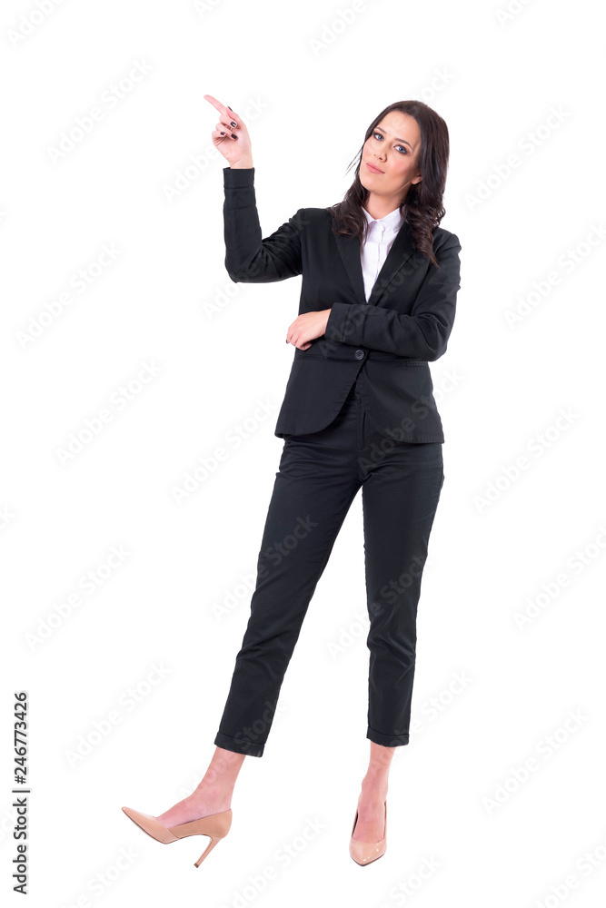 Confident business woman presenting with finger pointing up at copy space looking at camera. Full body isolated on white background. Confident business woman presenting with finger pointing up at copy space looking at camera. Full body isolated on white background.